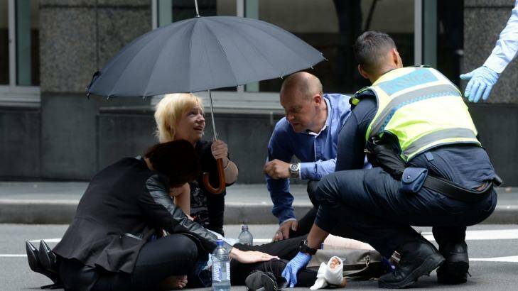 A person receives treatment in the aftermath of the Bourke Street incident Photo: Justin McManus