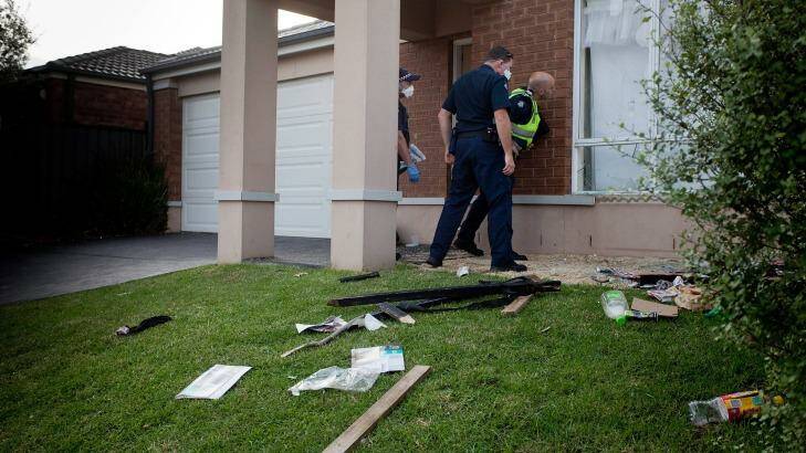 Police inspect the damage to the Point Cook party house.  Photo: Arsineh Houspian