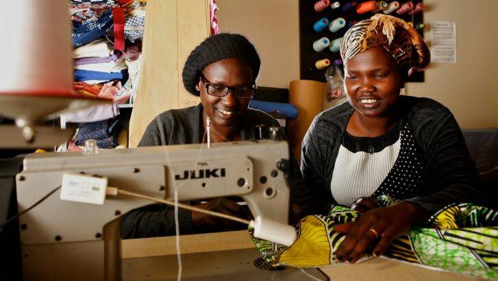 Role model: Abuk Bol (right) now runs the outlet and teaches other refugees. Photo: Eddie Jim
