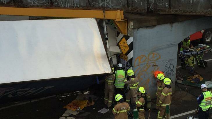 Fire crews frantically try to free the trapped truck driver. Photo: Eddie Jim