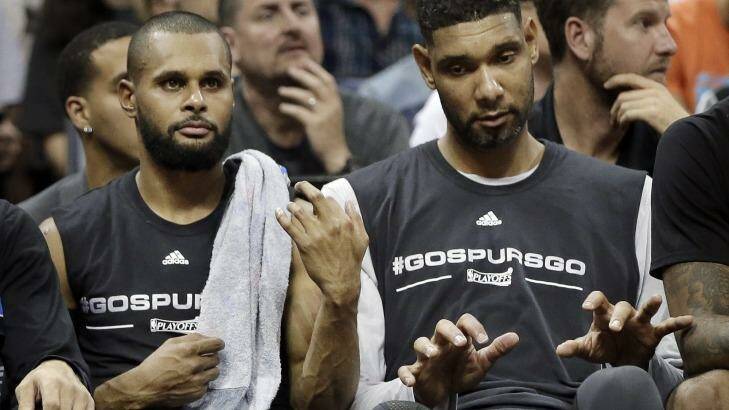 In harmony: San Antonio Spurs guard Patty Mills plays air guitar and veteran Tim Duncan joins in on the keyboards. Photo: Mark Humphrey