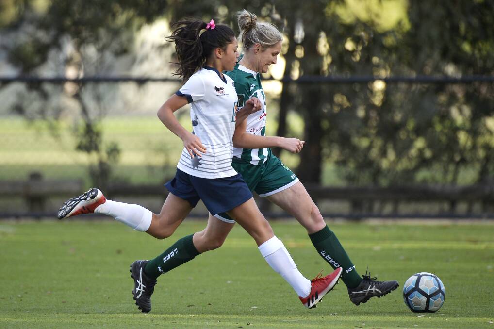 ATHLETIC: Lucius Dorothy of the Ballarat Eureka Strikers and Karla McKinnon of the Forest Rangers chase after the ball during Sunday's clash at Morshead Park. 