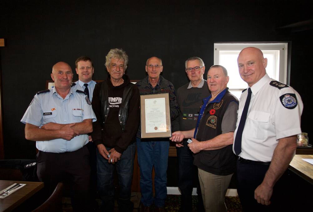 COURAGE: (L-R) Captain Michael Rowe, CFA District 15 operations manager Brett Boatman and recipients Donald Coward, John McNabb, Neil Shiells and Jim McKay, and Emergency Management Commissioner Craig Lapsley.



