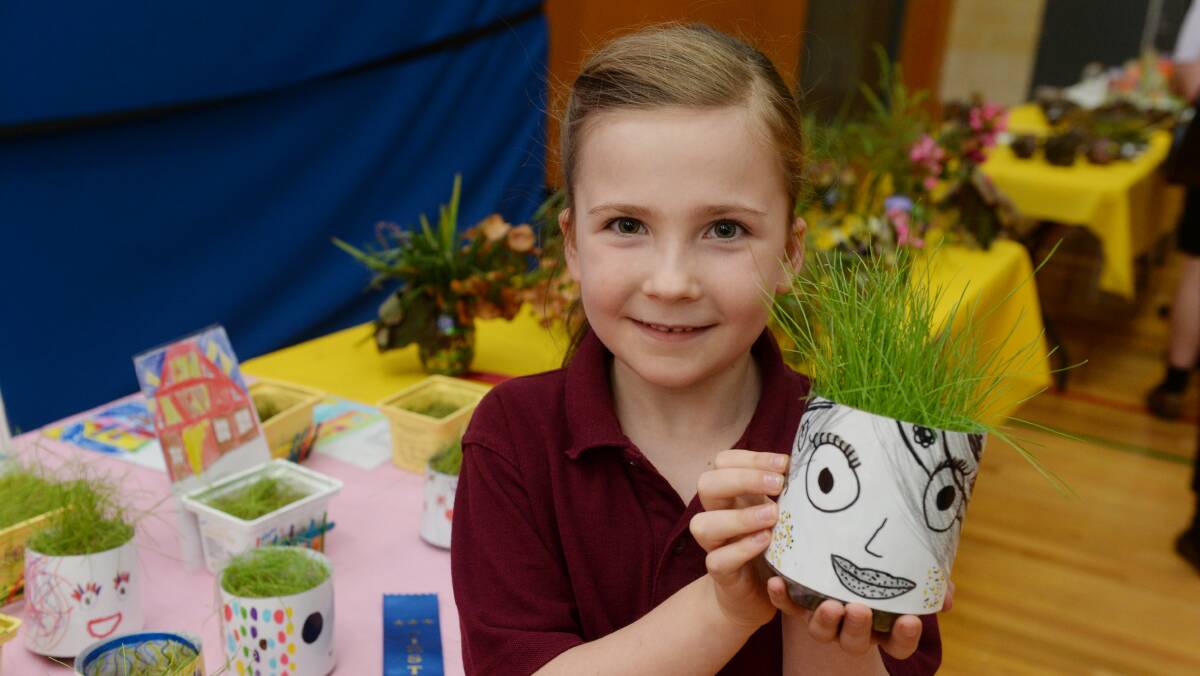 PROUD: Emily, year 2, at the Ballarat Christian College Garden Show holding a clay pot she decorated. The show included morning tea with loved ones. Picture: Kate Healy 