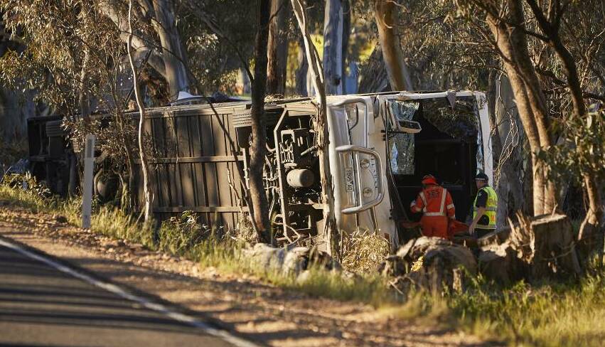 Police and SES workers inspect the bus near Avoca. Picture: Luka Kauzlaric