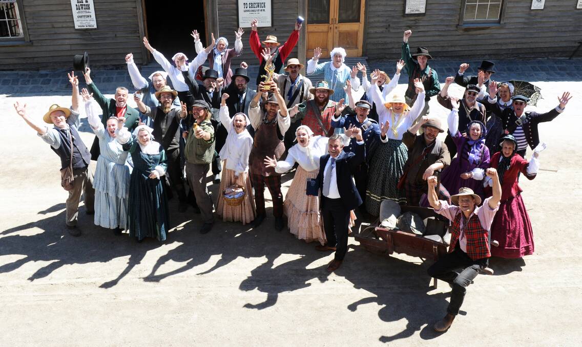 GOLDEN GLOW: Sovereign Hill staff and volunteers celebrated their second consecutive national tourism award with the trophy arriving at the outdoor museum this week. Picture: Kate Healy