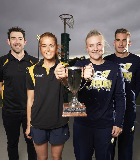 GAME ON: Springbank coach Garth Kydd, captain Kelly Conroy, Learmonth captain Eleisha Phelps and coach Jordan O'Keefe with the premiership cup at Mars Stadium's netball courts. Picture: Luka Kauzlaric