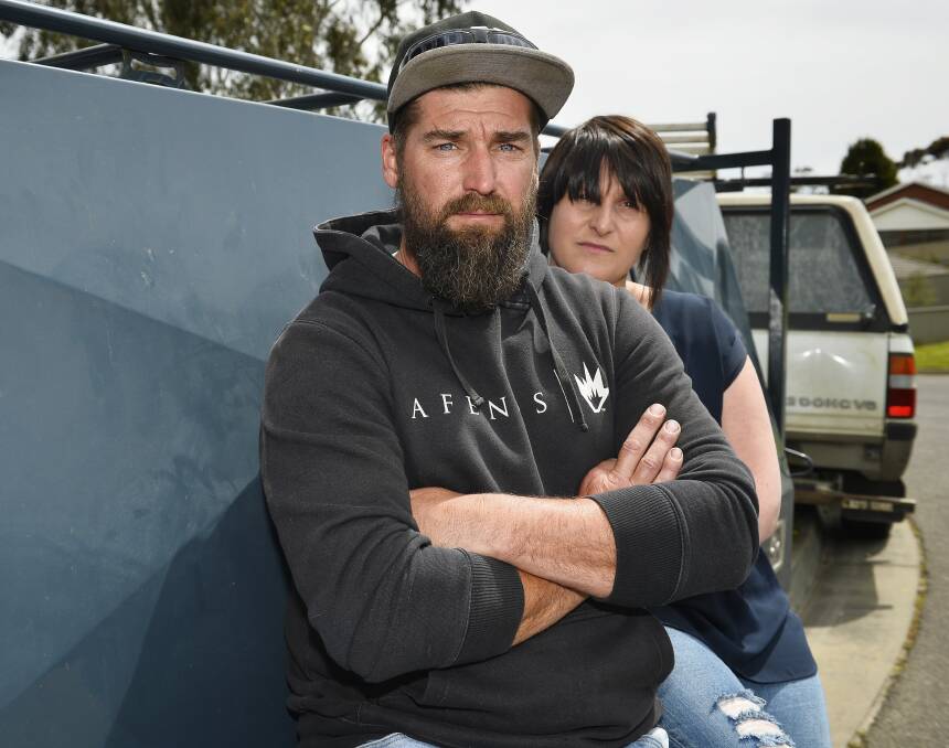 THEFT: Jason Tinetti and his wife Angela sitting by the trailer which was stolen from their home early Friday morning. Picture: Dylan Burns