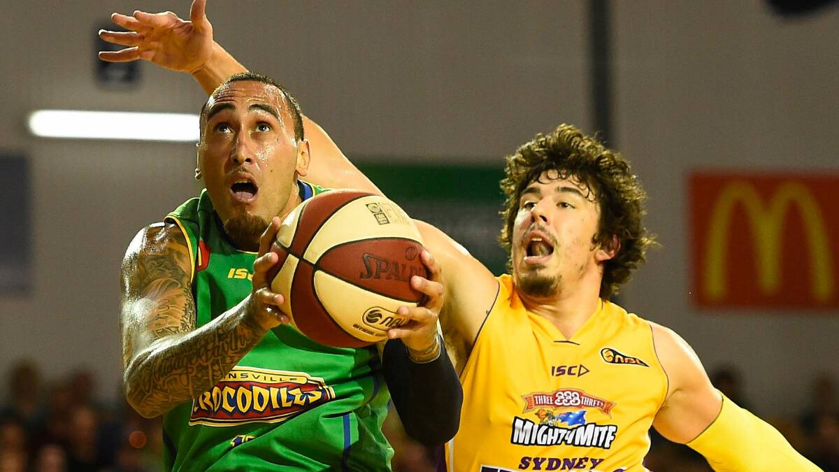 EXPERIENCE: Townsville Crocodiles' Leon Henry drives past Sydney Kings' Cody Ellis in the 2014-2015 season of the National Basketball League. Picture: Ian Hitchcock/Getty Image