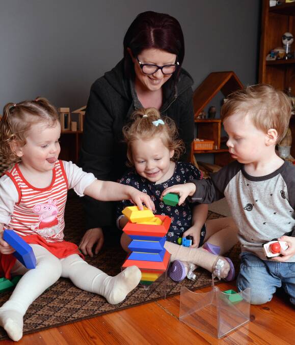 DAY CARE FUN: Melissa Dreger, pictured playing with Eva, 2, Charlotte, 2, and Harvey, 2, has been named the regional winner for Ballarat and Central Highlands in the 2016 Excellence in Family Day Care Awards. Picture: Kate Healy