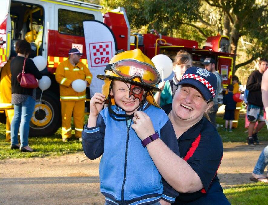 FESTIVAL FUN: The CFA had one of its fire trucks at the the festival last year with fire fighting gear keeping the children entertained. Picture: Ian Wilson 