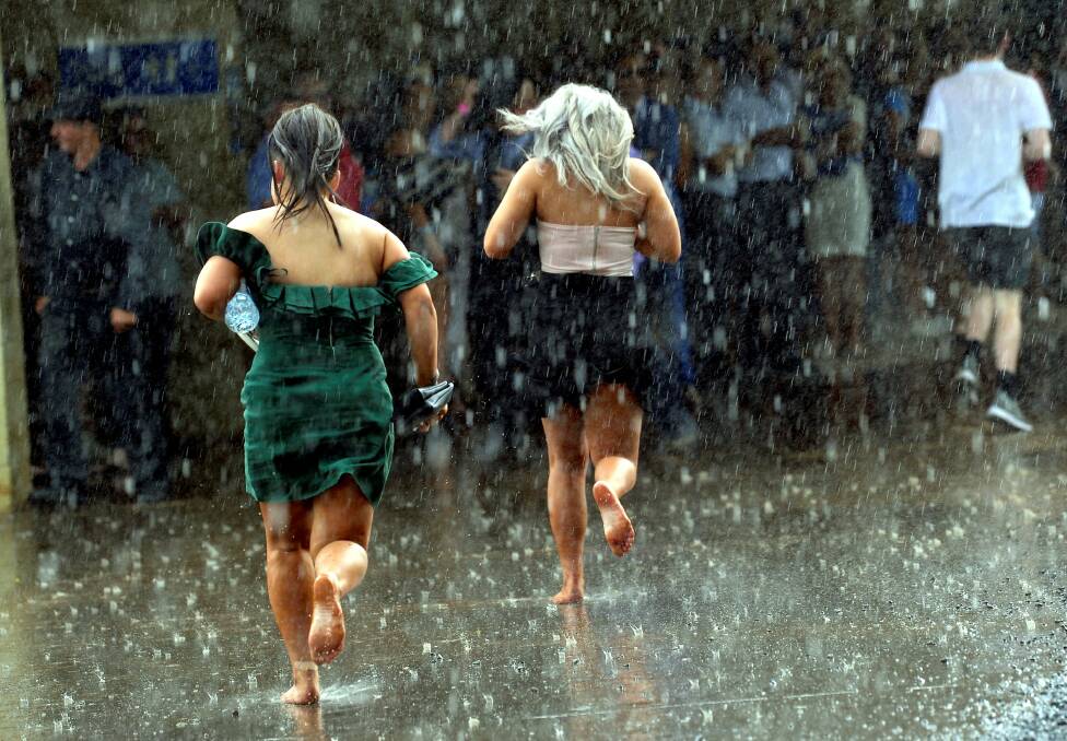 SEEKING SHELTER: Racegoers ran for cover as a change in weather brought about thunder, lightning and torrential rain in the early afternoon of the Ballarat Cup, but the weather did not dampen spirits or numbers. Picture: Lachlan Bence