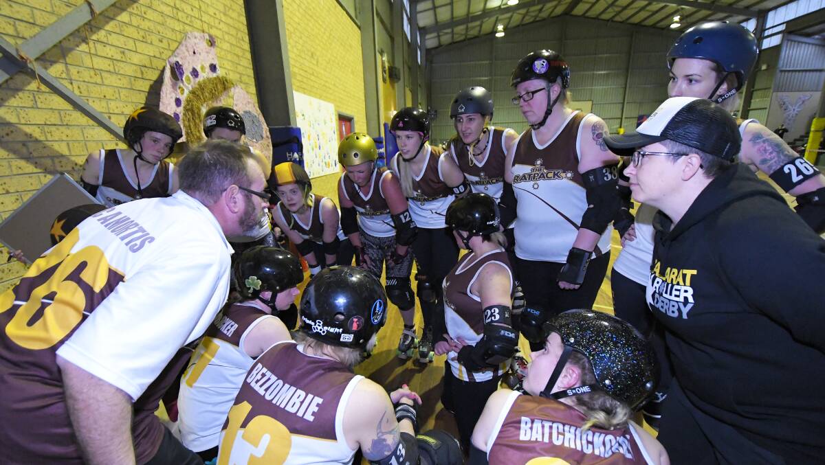 HUDDLE: Ballarat Roller Derby League coach Rick Cleary talks to the team at half time in what was an intense contest at Doug Dean Reserve.