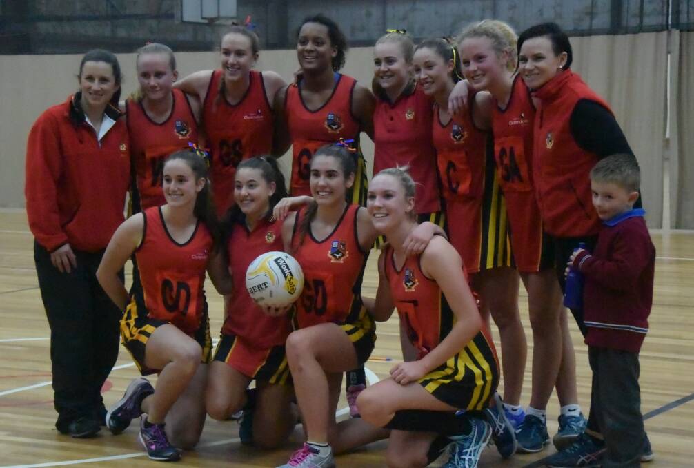 PROUD MOMENT: Ballarat Clarendon College's netball firsts squad poses for photos after winning the final over Ballarat Grammar on Tuesday. 
