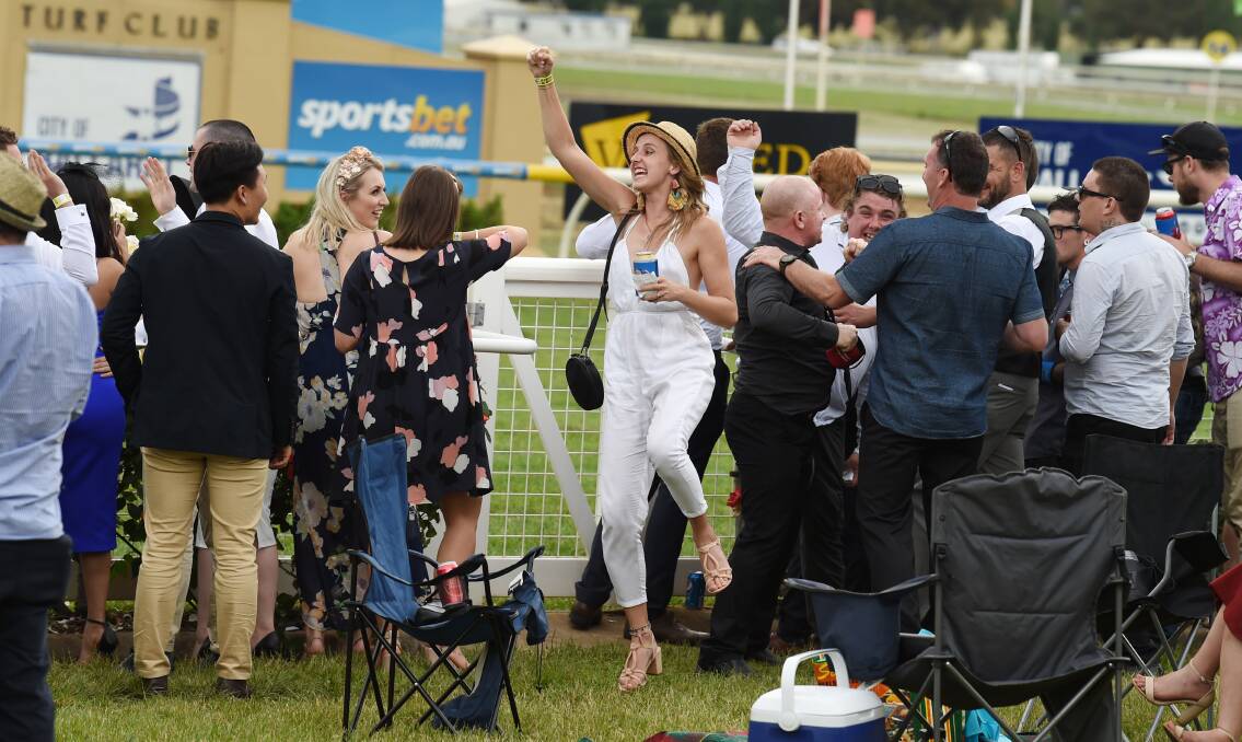CHEER: One punter was happy after the final race of the day. Picture: Kate Healy