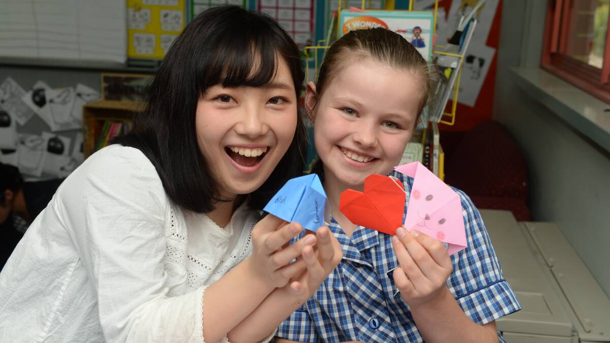 ORIGAMI FUN: Ayako Tanabe from Japan's Kanazawa Seiryo University and year 6 pupil Maddie spent time in the classroom learning from each other. Picture: Kate Healy