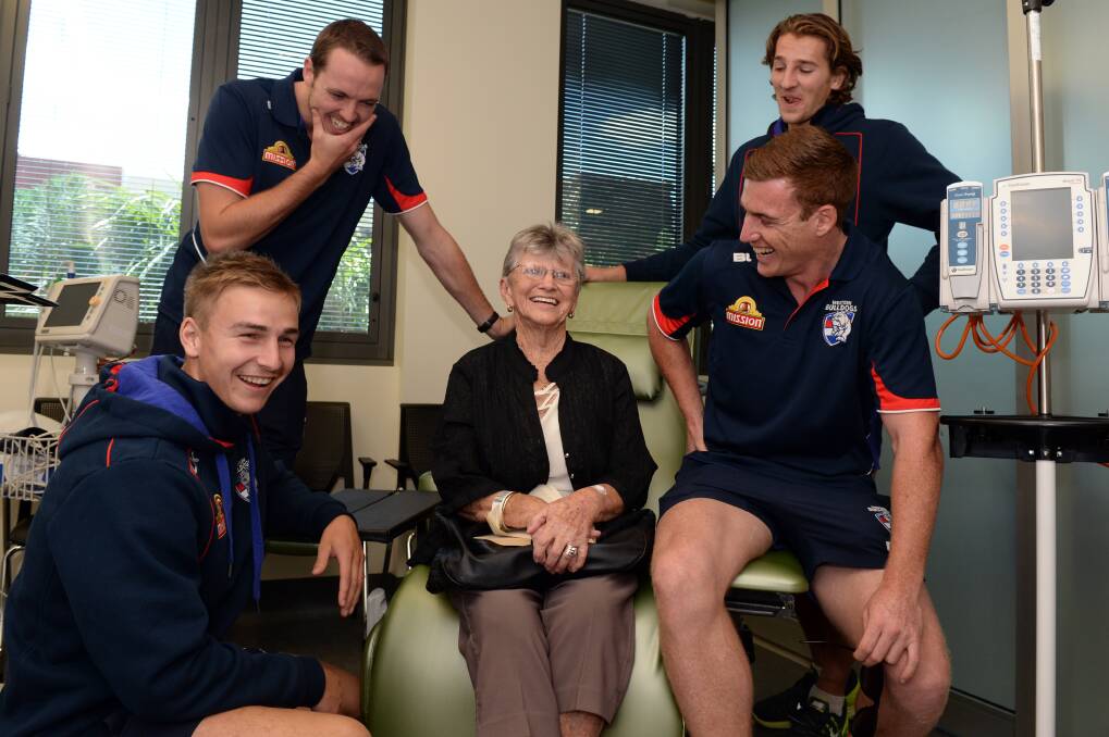 Western Bulldogs players Mitch Honeychurch, Ayce Cordy, Marcus Bontempelli and Matthew Fuller meet Betty Elizabeth at the Ballarat Regional Integrated Cancer Centre. PICTURE: Kate Healy.  