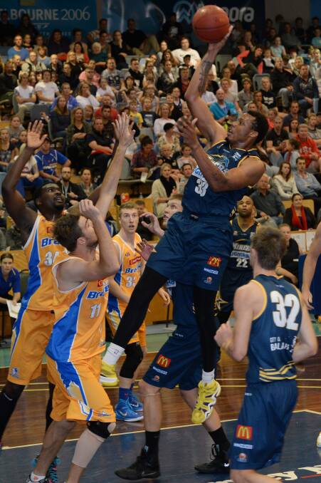 Rising high: Miner Kodi Augustus shoots while Braves Tony Lewis and Taylor Bell look on. PICTURE: KATE HEALY