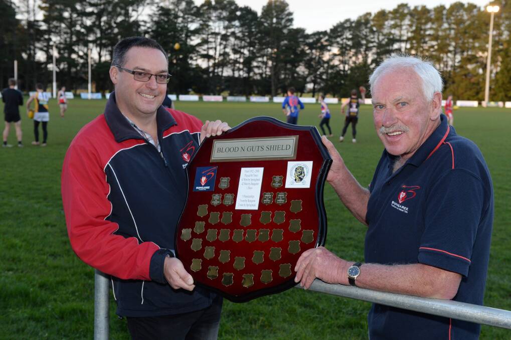 Old footy foes: Bungaree president Darren Rix and club legend Jim O’Keefe with the Blood N Guts Shield.