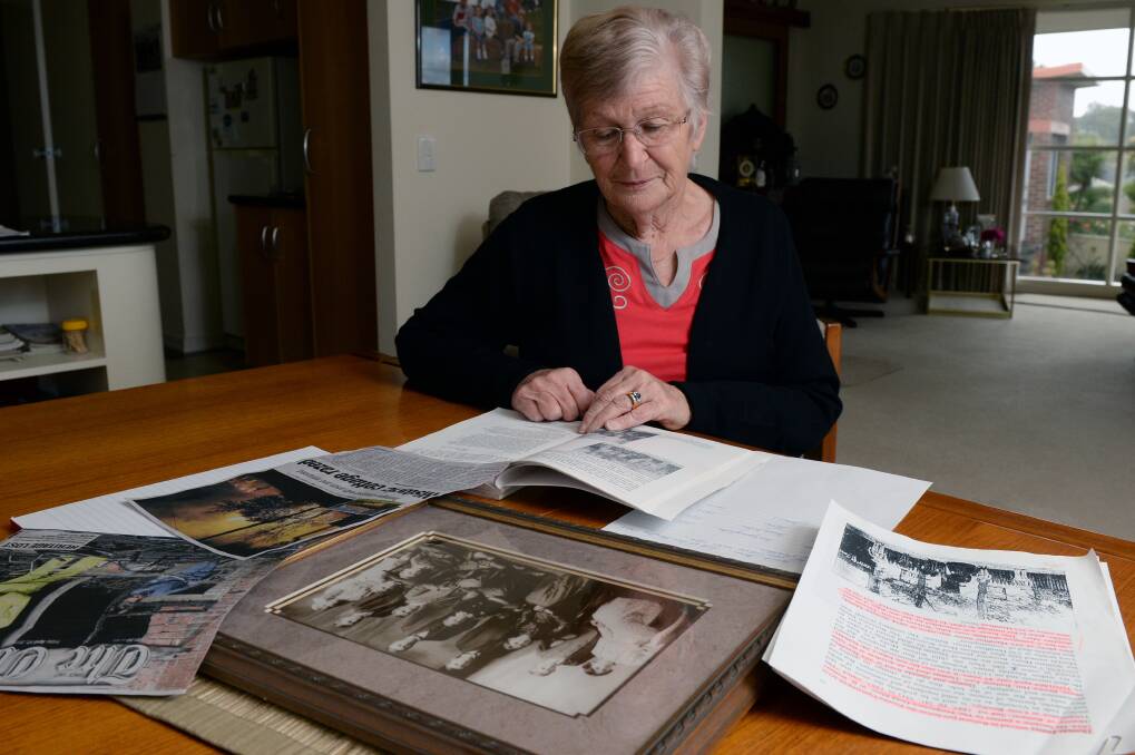 Research: Heather Mann has dug out her family records after her great-grandfather’s Humffray Street house was destroyed by fire on Wednesday. PICTURE: KATE HEALY