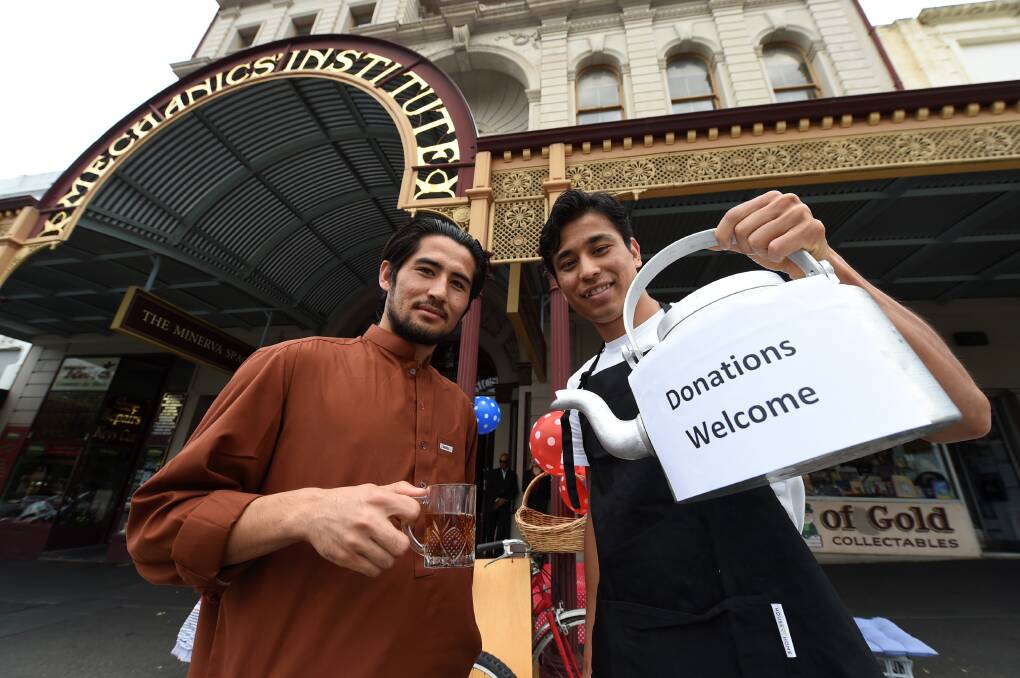 Happy to serve: M.Raza Hussaini and Ibrahim Ghulamr outside the pop-up Afghan-Hazara tea house. PICTURE: LACHLAN BENCE
