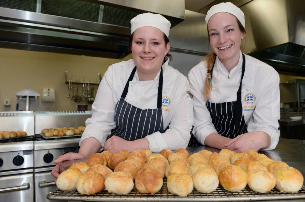 Golden: FedUni students Carley Kirby and Brittany Hook with their freshly baked bread. PICTURE: KATE HEALY