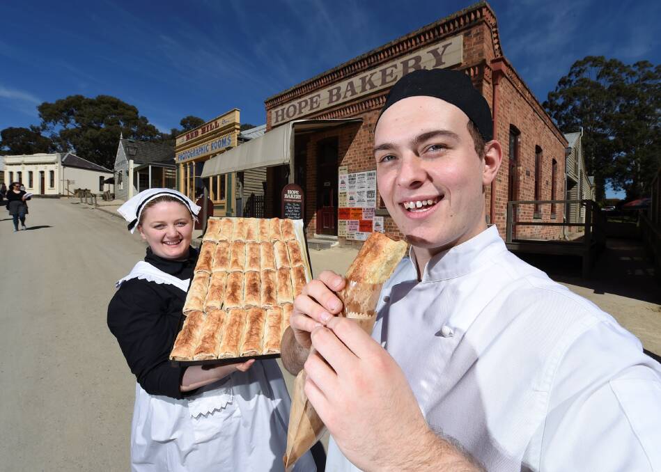 Tops: Caitlin Jenkins and baker Michael Pace proudly display Australia’s best sausage rolls, created at Sovereign Hill’s Hope Bakery. PICTURE: LACHLAN BENCE