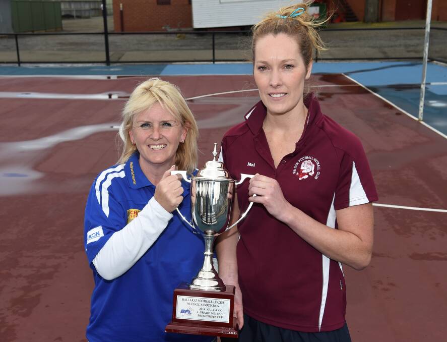 Sunbury coach Kim Bailey and her Melton counterpart Melissa McCauley with the premiership cup. Picture: Lachlan Bence