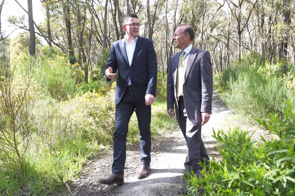 Pledge: State Opposition Leader Daniel Andrews and Ballarat East MP Geoff Howard walk in the proposed Canadian State Park. PICTURE: LACHLAN BENCE