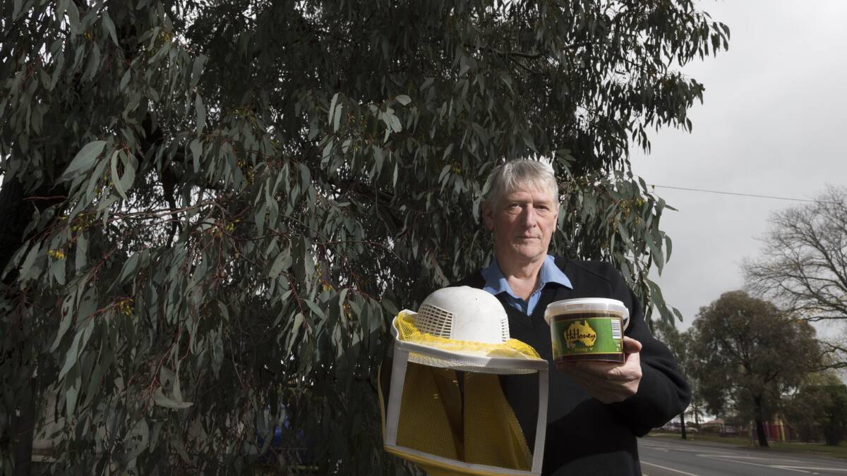 Warning: Beekeeper Gavin Jamieson with a container of the Turkish honey, which might not even be honey at all. PICTURE: JUSTIN WHITELOCK