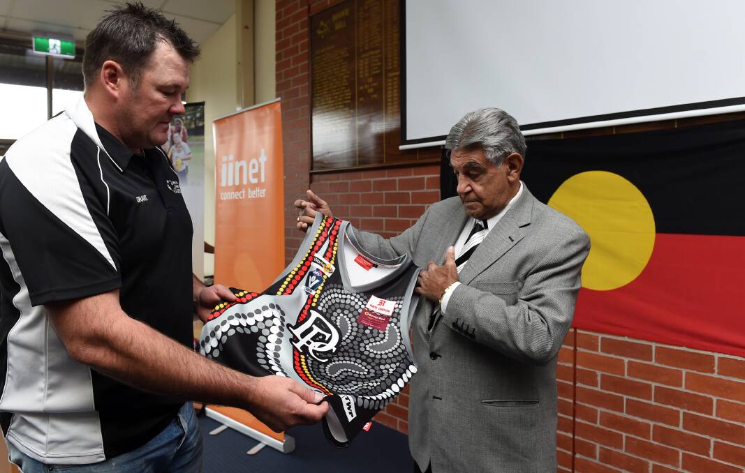 Reconciliation: Darley Football Club president Grant Wright presents the specially designed Indigenous jumper to Ballarat Aboriginal elder Ted Lovett. PICTURE: LACHLAN BENCE