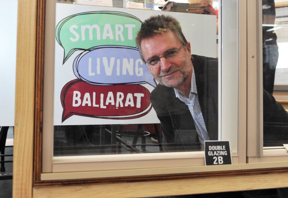 Clear benefits: BREAZE spokesman Ian Rossiter inspects the double glazing on the volunteer group’s window at the Ballarat Library. PICTURE: JEREMY BANNISTER