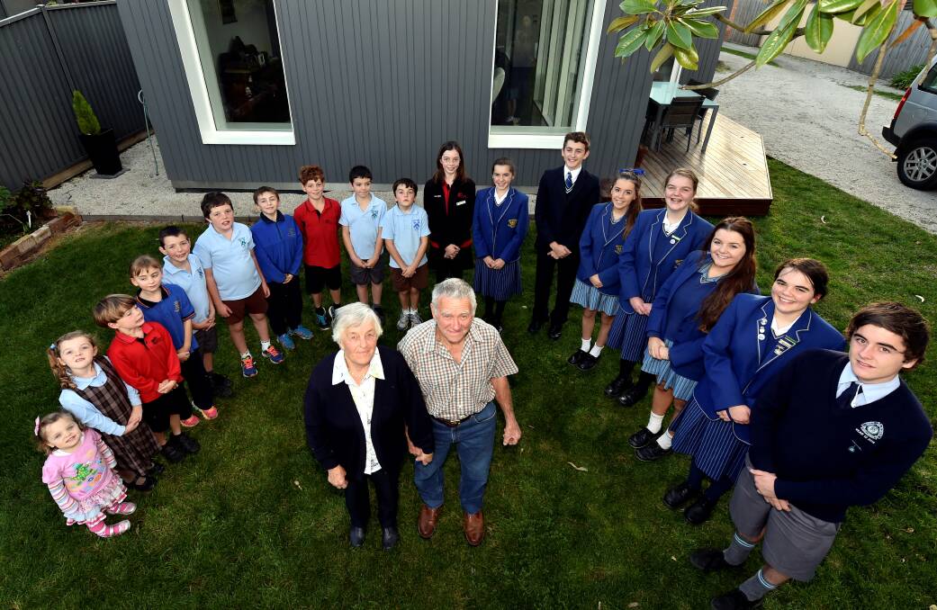Bill and Mary Harwood with their 18 grandchildren who, between them, cover every year of school, ranging from Summer Harwood (kinder), Chloe Harwood (prep), Thomas Campbell (grade one), Kate Porter (grade two), Connor and Lewis Harwood (both grade three), Patrick Porter, Andy Campbell and Jack Harwood (all grade four), Evan Harwood (grade five), Georgina Campbell (grade six), Sarah Porter (year seven), Simon Porter (year eight), Olivia and Joy Harwood (both year nine), Brooke Harwood (year 10), Amy Harwood (year 11) and Nathan Harwood (year 12). PICTURE: JEREMY BANNISTER