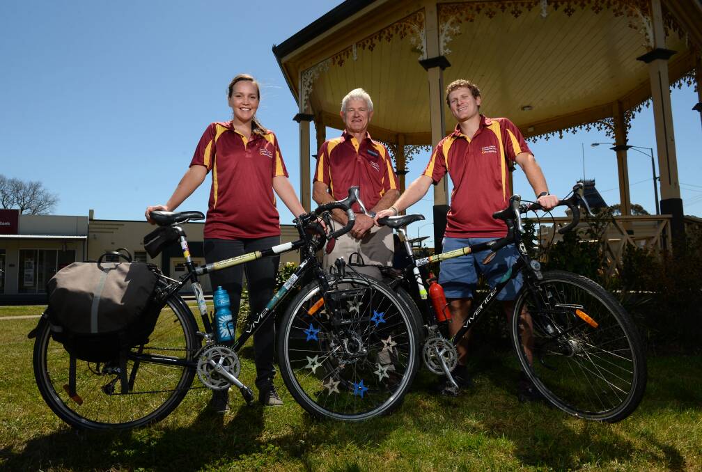 TREK: Dan Rule and his partner Jess Mumford, pictured with Creswick Community Bank director Michael Daunt, cycled through different countries to raise money for Ultimate Peace. PICTURE: ADAM TRAFFORD