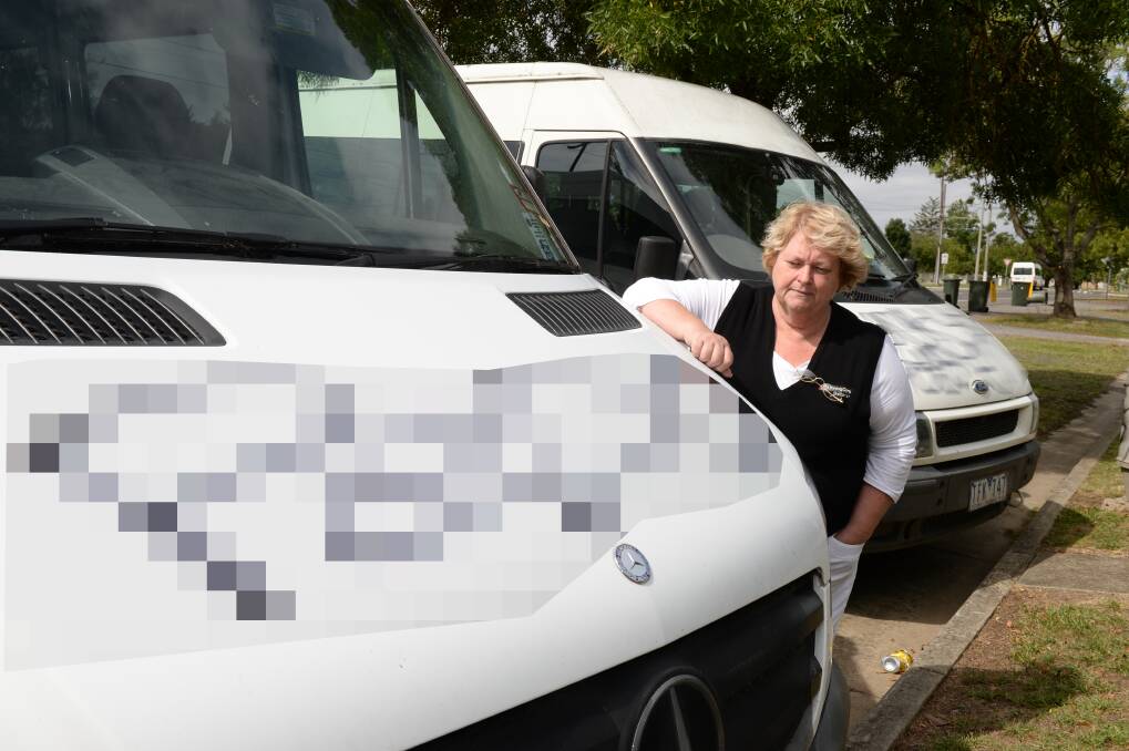 Low act: UnitingCare Ballarat aged and disability, OHS and quality manager Gail Reid inspects the vandalism to UnitingCare buses. The area has been hit three times in as many weeks by vandals. PICTURE: KATE HEALY