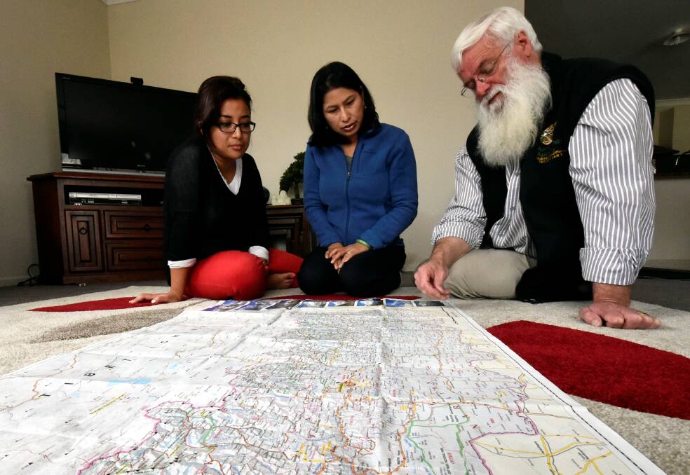 Wanting to help: Ballarat Nepali women Shruti Shrestha and Roshani Kattel and Aussie Action Abroad director Graeme Kent map out their plans. PICTURE: JEREMY BANNISTER