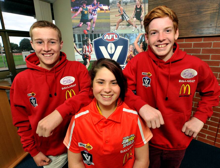 All set for state carnival: Division one representative Mitch Tuddenham and division one player Blake Salmon with youth girls footballer Gab Leckie showing off the Ballarat colours. PICTURE: JEREMY BANNISTER