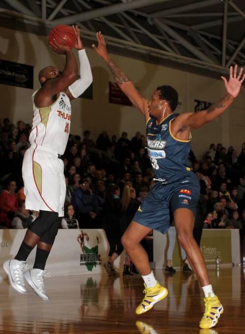 Strong defence: Thunder’s Fred Hunter puts up a shot against defending Miner Kodi Augustus. PICTURE: THE ADVOCATE