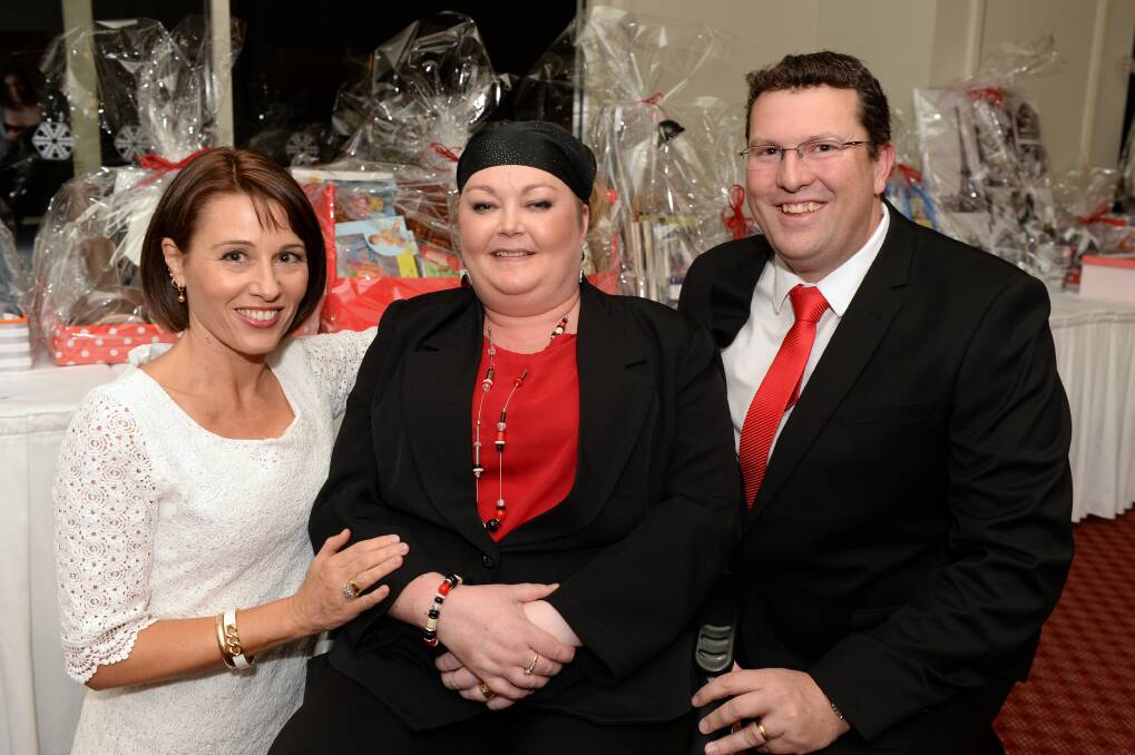 Sue’s angel:  Fundraiser organiser Lisa Pierce with Sue and Chris Cornish.
PICTURE: KATE HEALY