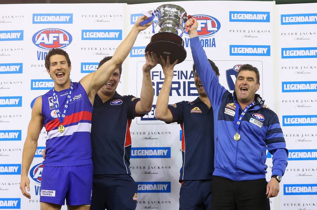 Triumphant: Jordan Russell, injured captains Lukas Markovic and Nick Lower and Footscray coach Chris Maple celebrate their VFL victory. PICTURE: GETTY IMAGES