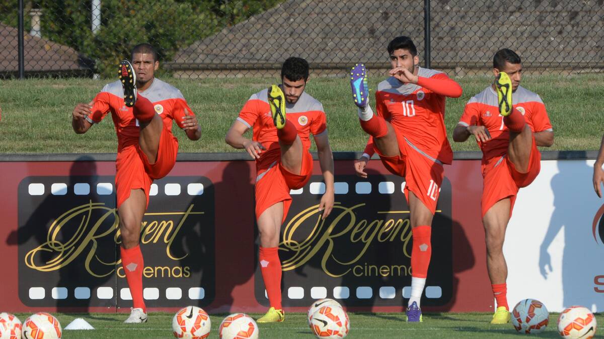 Welcome: Members of Bahrain’s national soccer team limber up before their first training session at Ballarat’s Morshead Park on Sunday in preparation for the Asian Cup 2015.
PICTURE: KATE HEALY