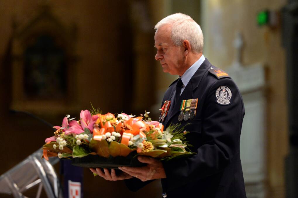 Remembering: Volunteer Fire Brigades Victoria state president Hans van Hamond lays a wreath at the ceremony. PICTURE: KATE HEALY