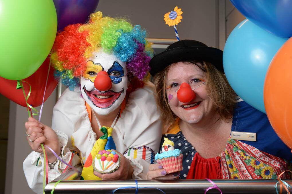 Humourous: ComBank staff members Jasmine Jolly and Pauline Lowson dressed as clowns and sold cupcakes to raise funds for Clown Doctors. PICTURE: KATE HEALY