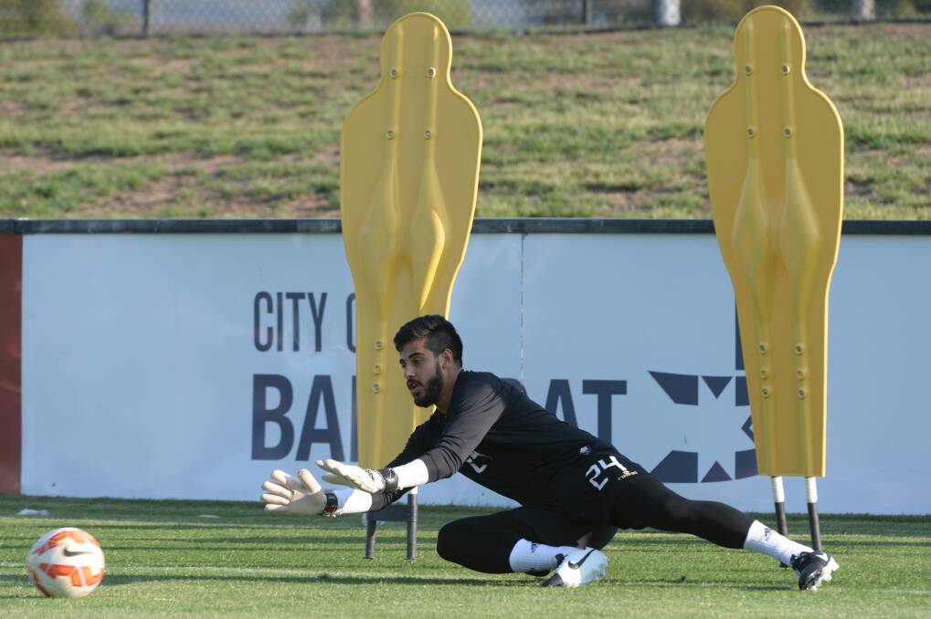 In control: Goalkeeper Ashraf Waheed keeps his eyes on the ball during Sunday’s training session.
