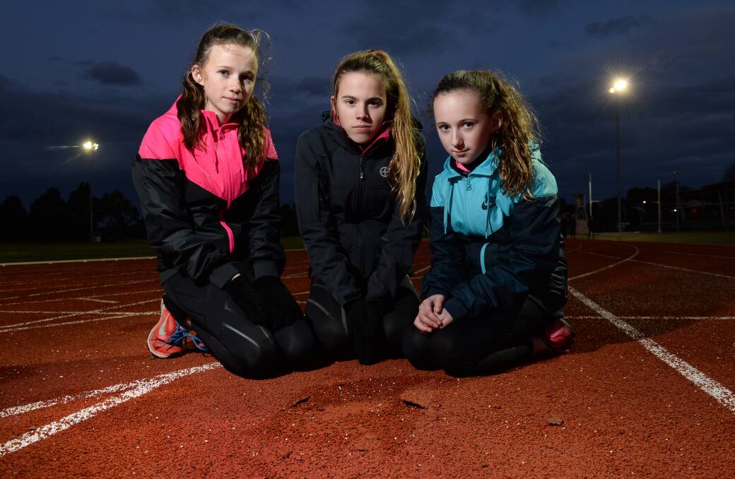 Damage: Young athletes Talia Martin,13, Tiana Shillito,14, and Halle Martin,10, on the Llanberris Reserve running track which is falling into disrepair.
PICTURE: ADAM TRAFFORD