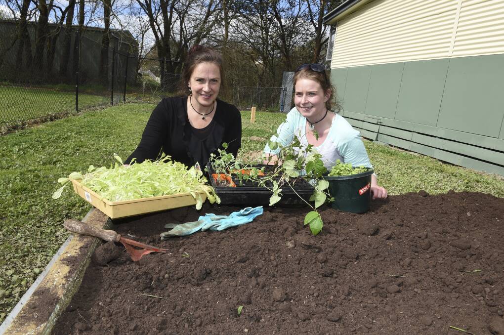 Gardening: Sustainable Living teacher Liz Kelly and student Demi Swire at work in the vegie patch. PICTURE: LACHLAN BENCE