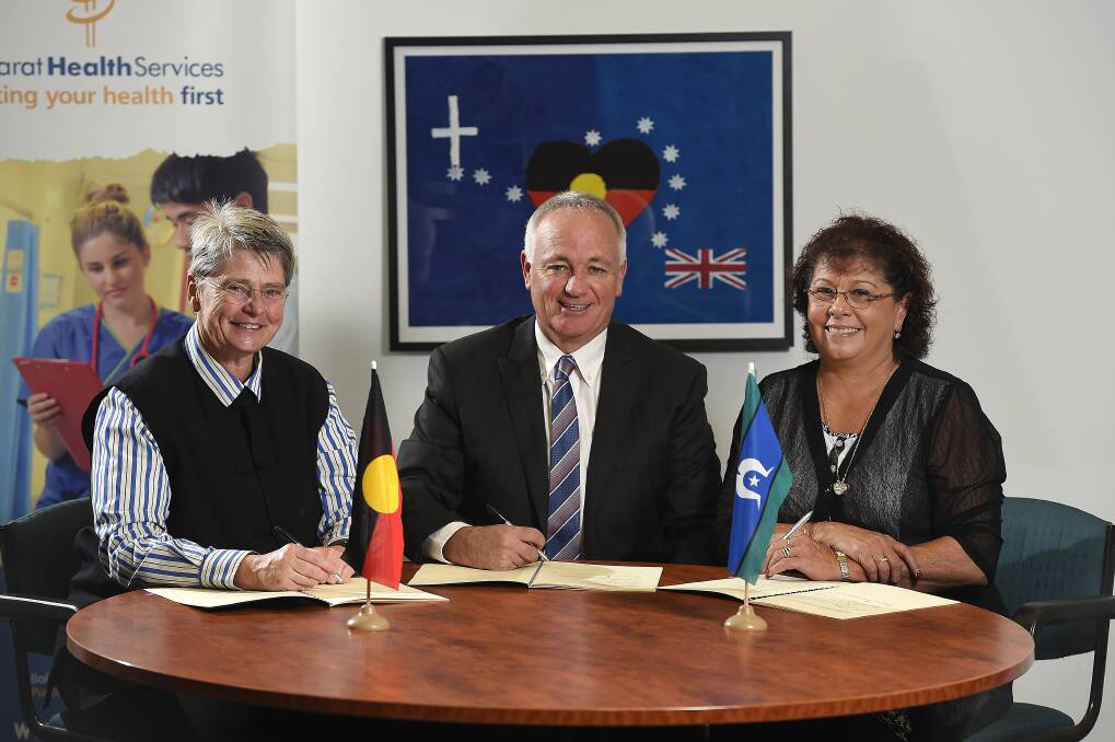 Deal: Ballarat Health Services mental health executive director Tamara Irish, BHS chief executive officer Andrew Rowe and Ballarat and District Aboriginal Co-operative CEO Karen Heap sign the agreement. PICTURE: JUSTIN WHITELOCK    