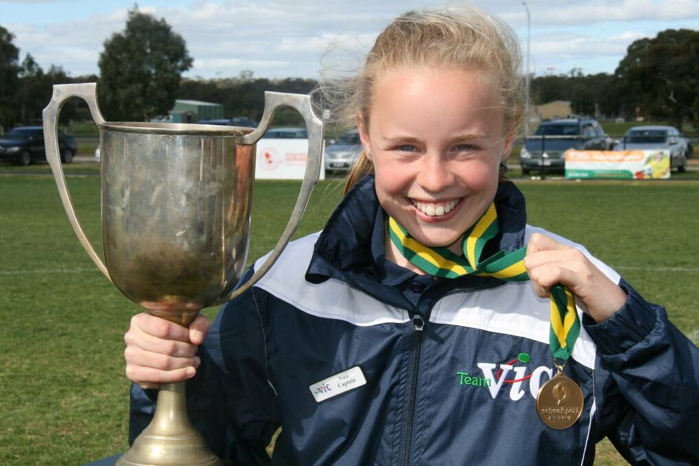 Vice-captain: Annie Bissinella with the cup and medal. picture: School Sport Victoria