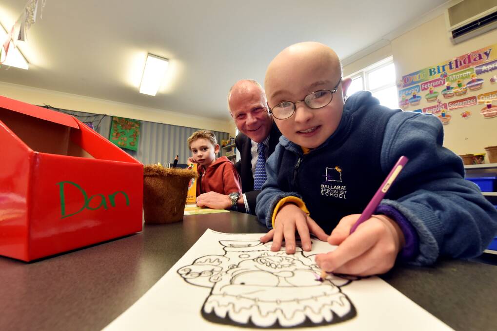 Learning: Wendouree Liberal candidate Craig Coltman with Ballarat Specialist School pupils Samuel Hewat-Pappas and Daniel Bell during his stint as principal for a day. PICTURE: JEREMY BANNISTER