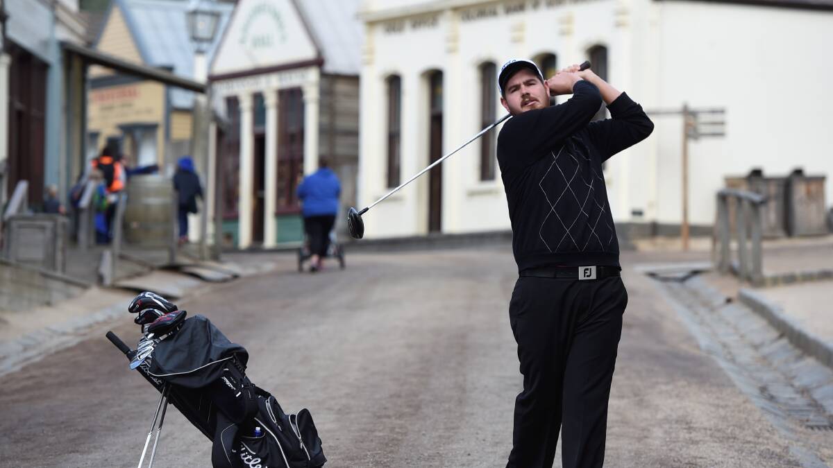 Fore: Top-ranked golf trainee Deyen Lawson practises his swing at Sovereign Hill. PICTURE: LACHLAN BENCE